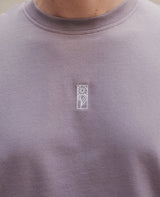 Blume Oversized T-Shirt Lila von NKSP – Nahaufnahme der weißen Stickerei